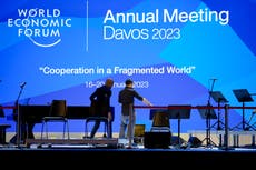 As elites arrive in Davos, conspiracy theories thrive online