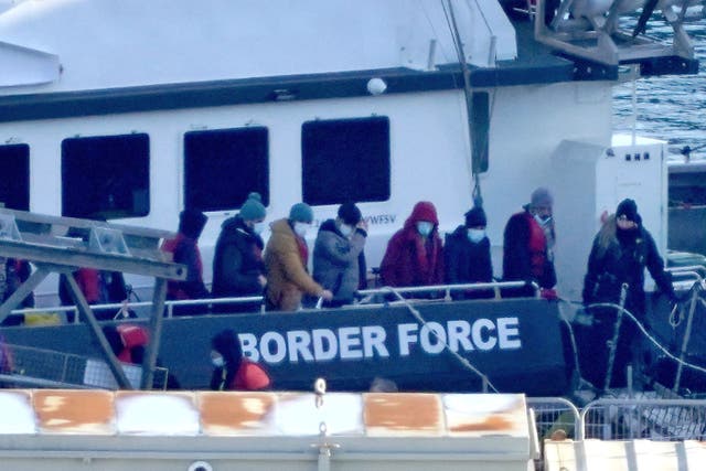 A group of people thought to be migrants are brought in to Dover (PA)