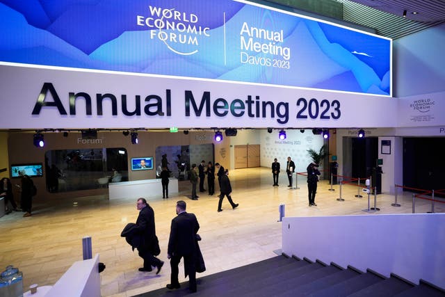 <p>People gather in the Davos Congress Centre prior to the start of the World Economic Forum</p>