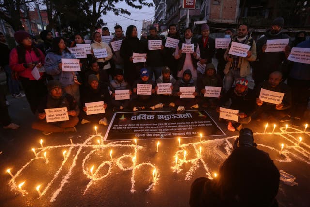 <p>People observe a candlelight vigil in memory of victims of a plane crash in Kathmandu</p>