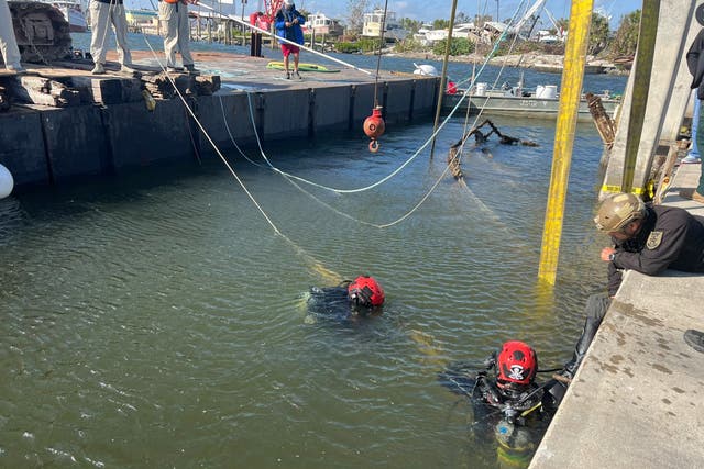 <p>Lee County divers search the wreckage of a sunken sailboat where the remains of James “Denny” Hurst — who attempted to ride out Hurricane Ian — were found</p>