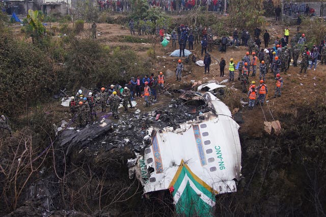 <p>Rescue teams working near the wreckage of a crashed Yeti Airlines plane in Nepal in January 2023 </p>