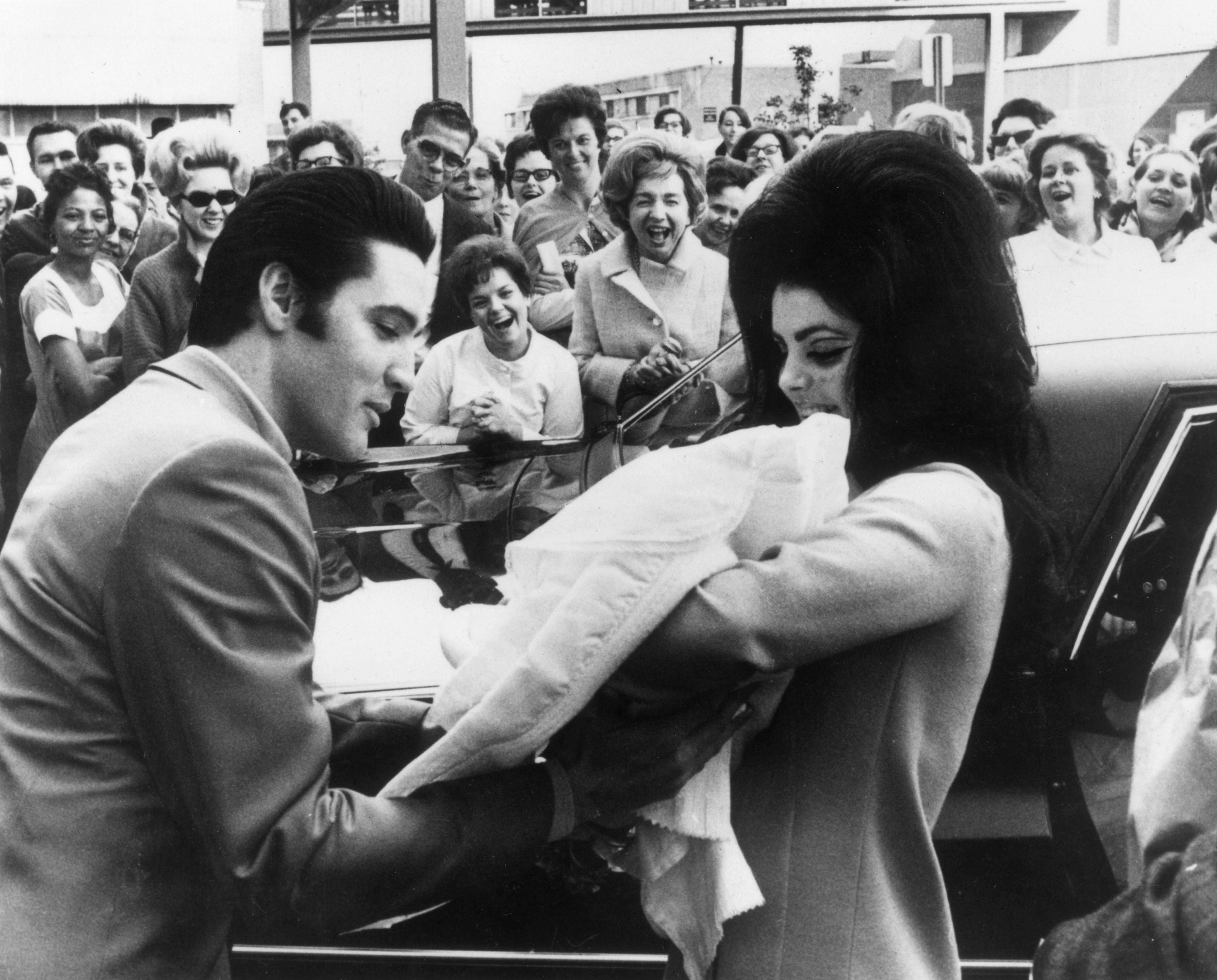 Elvis and Prescilla Presley holding Lisa Marie after she was born