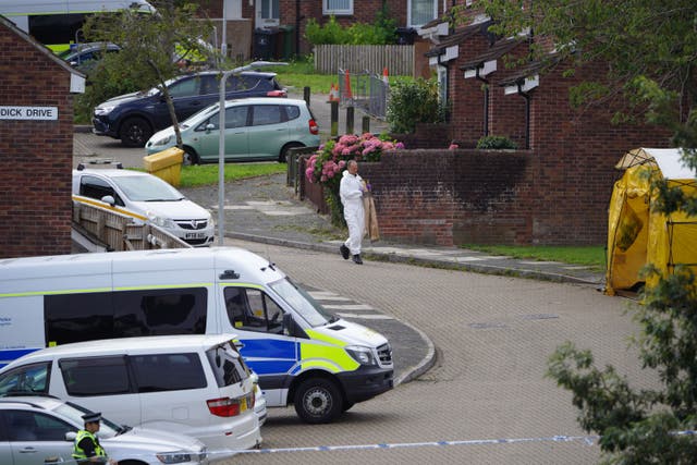 A forensic officer carries an evidence bag in Biddick Drive in the Keyham area of Plymouth, Devon, where five people were killed by gunman Jake Davison in a firearms incident on Thursday evening. Picture date: Sunday August 15, 2021.