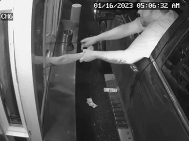 <p>Police are hunting a man seen on video trying to abduct a barista via a drive-through window</p>
