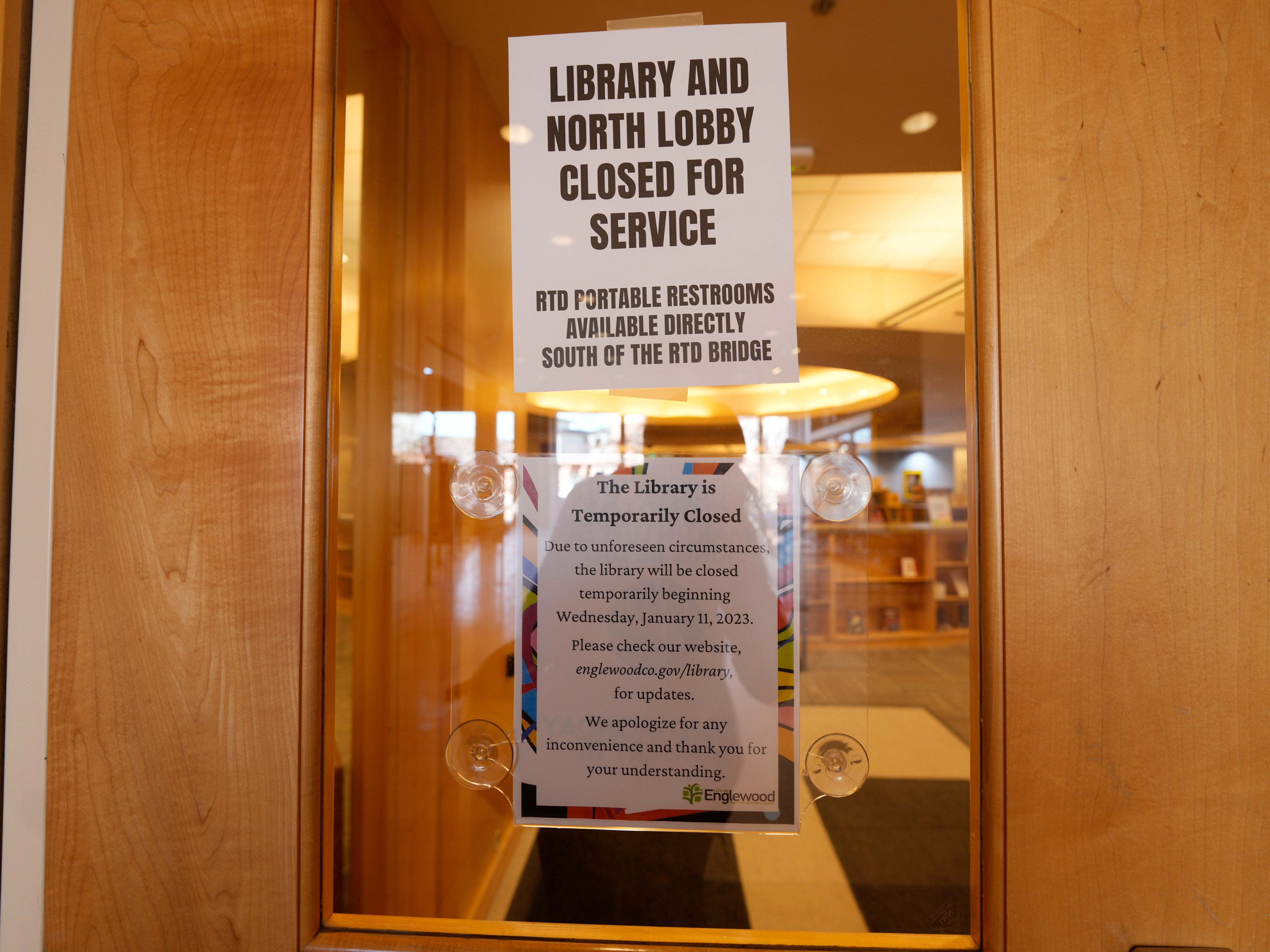 Signs are placed on the outside doors to advise visitors that the library as well as a restroom are closed because of meth contamination Thursday, Jan. 12, 2022, in the south Denver suburb of Englewood, Colo. (AP Photo/David Zalubowski)