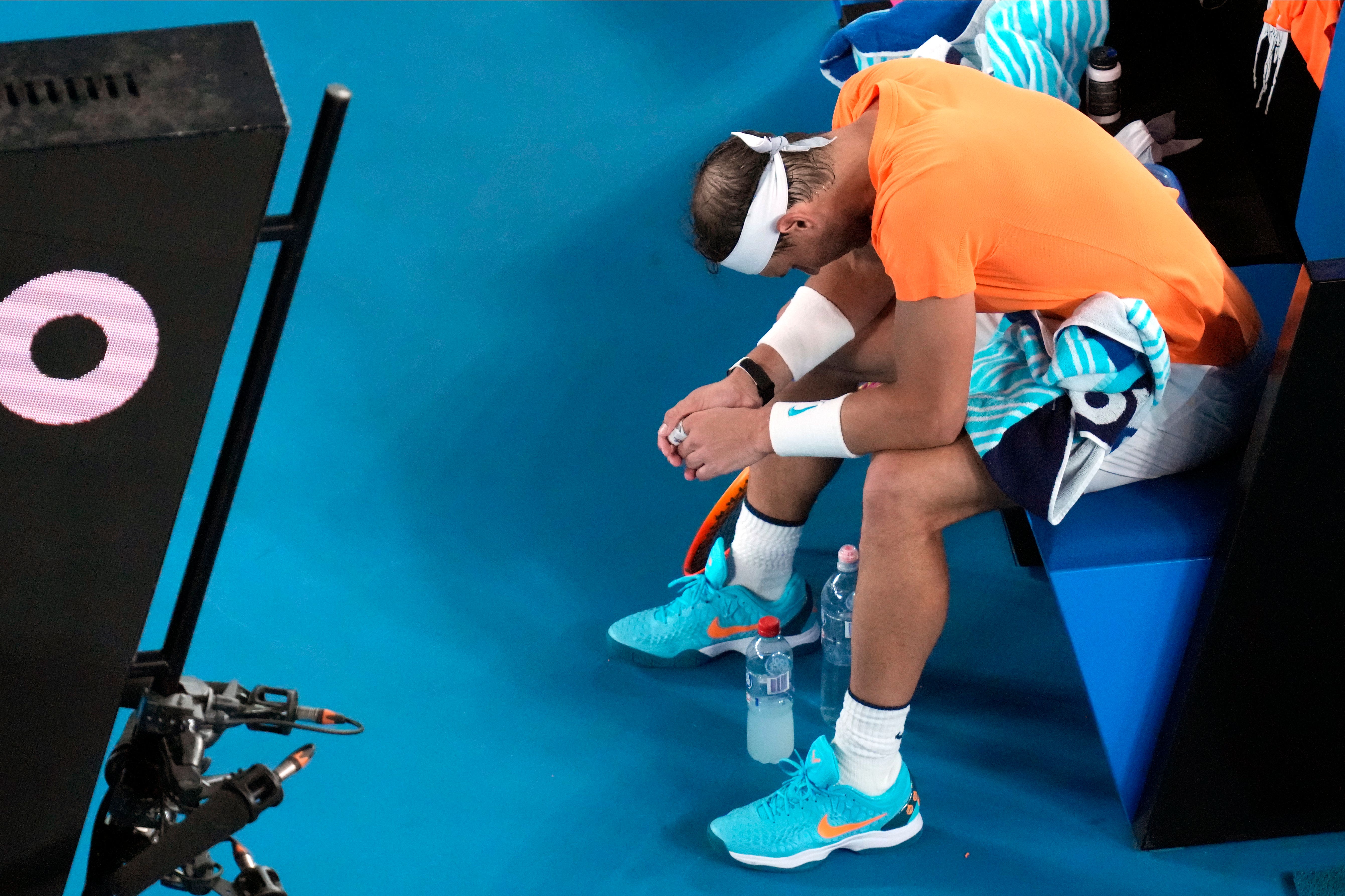 Rafael Nadal hangs his head after suffering an apparent hip injury