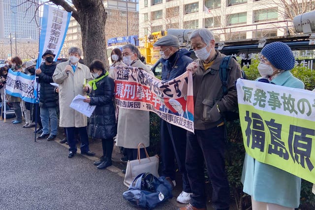 <p>Fukushima residents and their supporters protest outside the court</p>