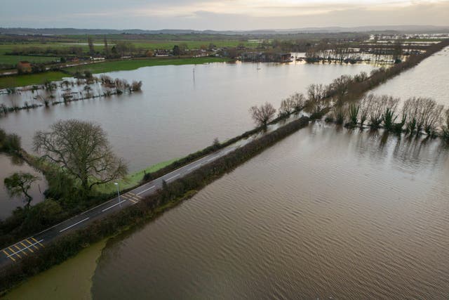 <p>Flood water surrounds the A361 road in Burrowbridge due to widespread flooding of the Somerset Levels</p>