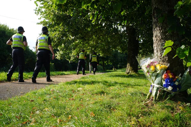Police officers patrol the area after the deadly gun rampage in Keyham