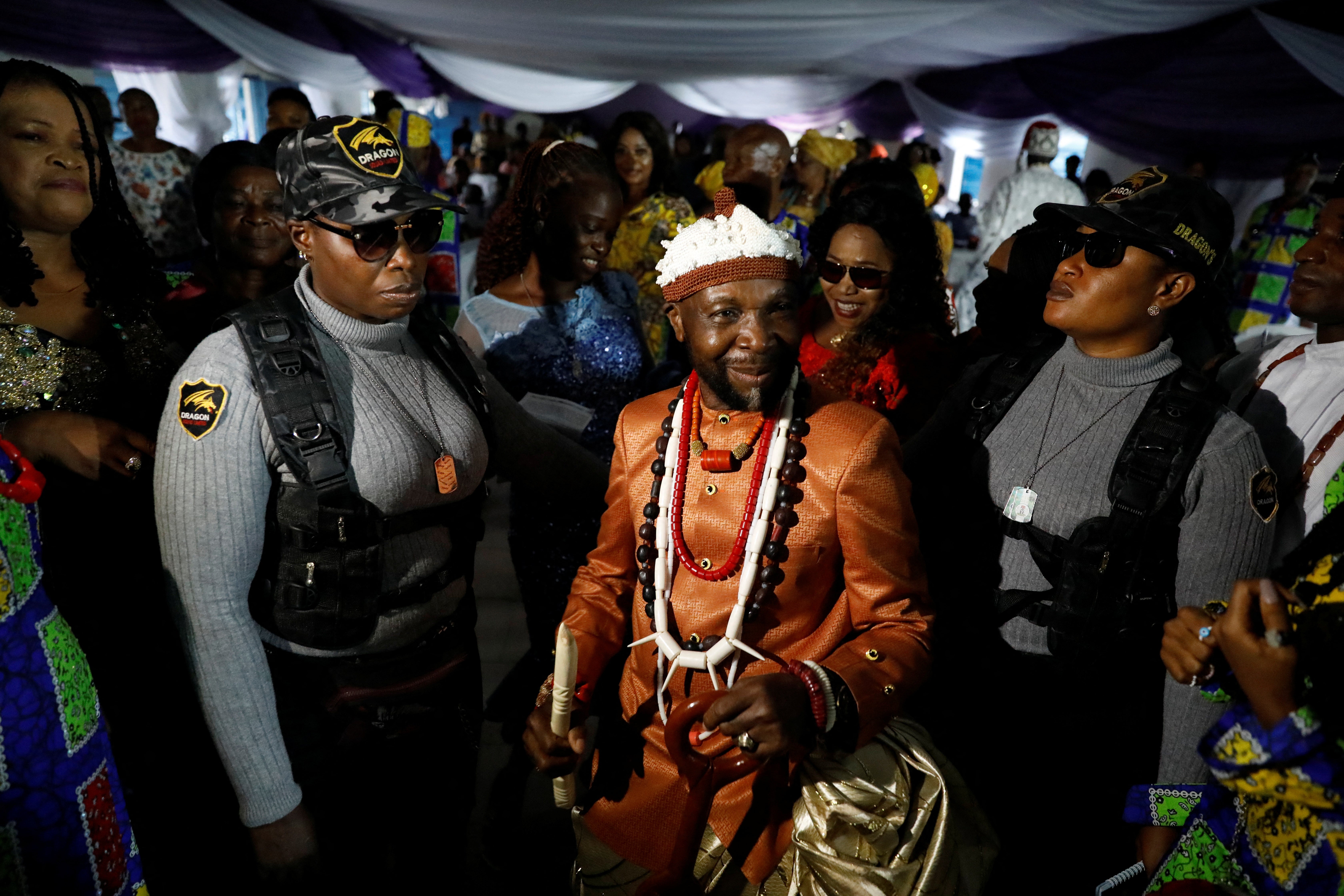 Esther Brown and Ukeme Tom guard newly crowned king Obong Ibanga Ikpe at his coronation ceremony