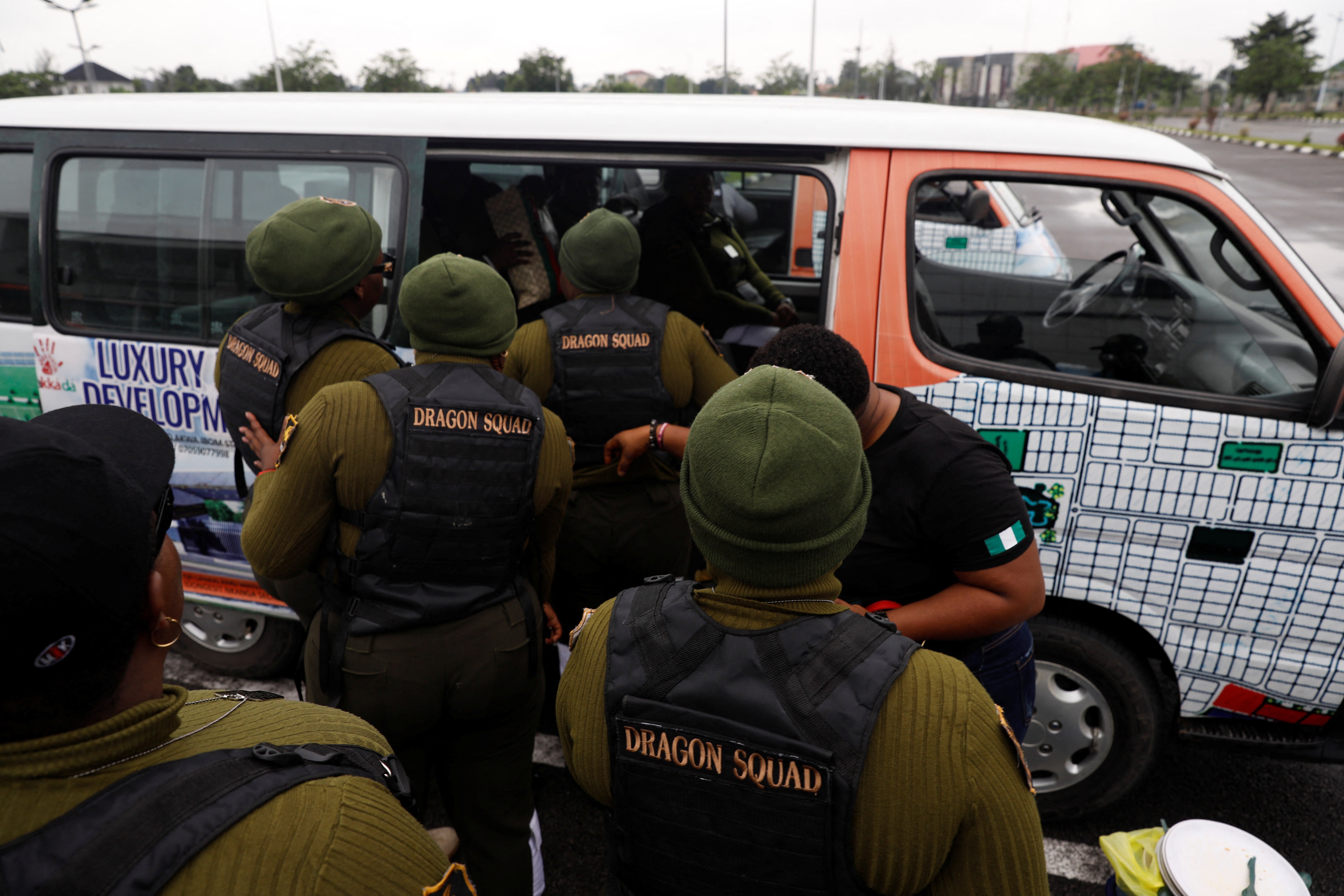 The female-only security team get into a bus as they head to work at a funeral event in Etinan