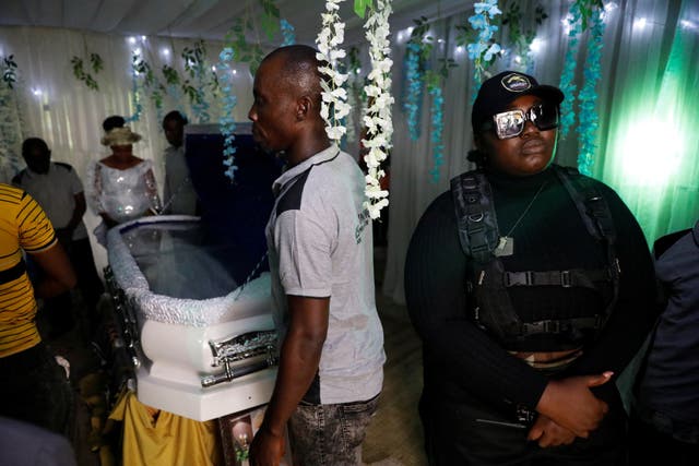 <p>Enobong Udofia, a member of the female-only security team Dragon Squad Limited, stands guard at a funeral event in Etinan, Akwa Ibom, Nigeria</p>