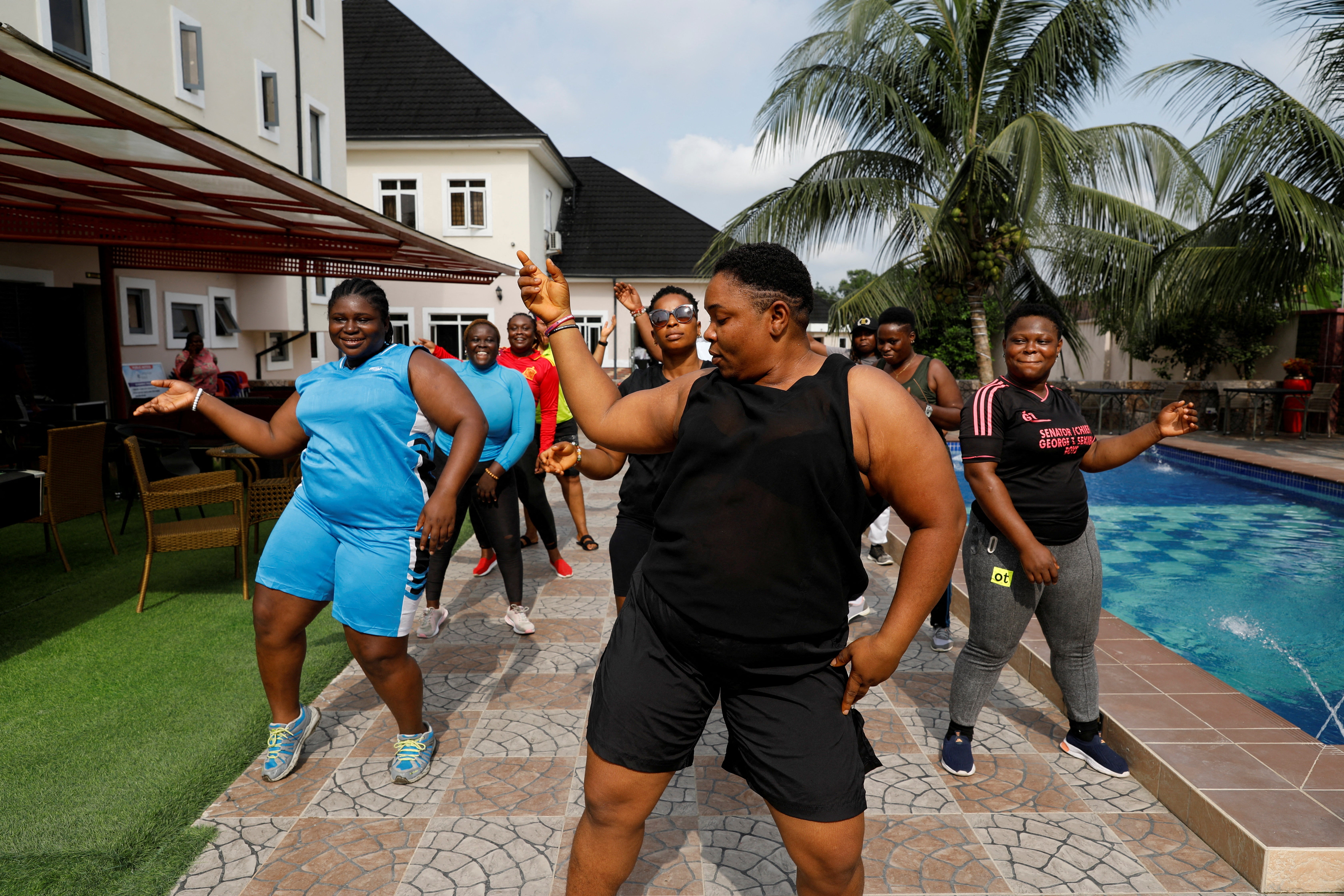 Members of Dragon Squad Limited dance during an exercise session at Camp Gee Hotel