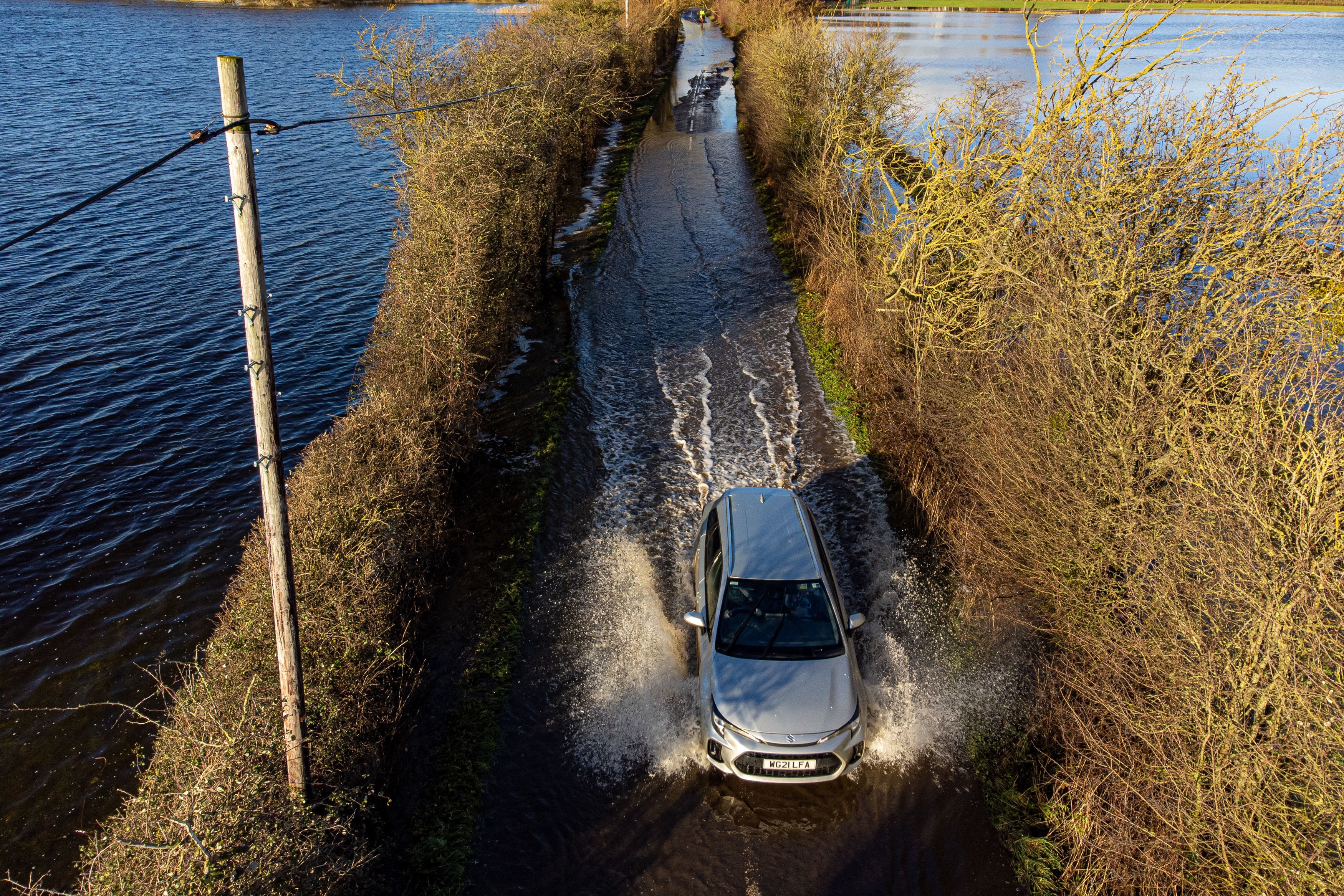 A car drives through floodwater near Muchelney