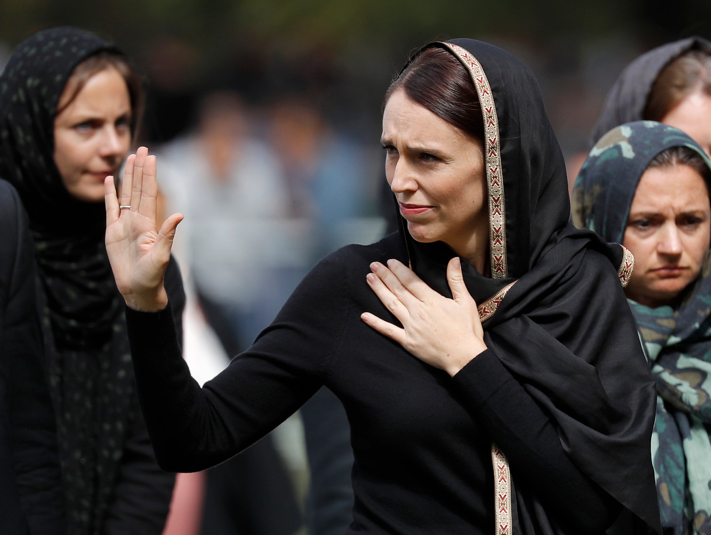Jacinda Ardern, centre, waves as she leaves Friday prayers at Hagley Park in Christchurch, New Zealand in 2019