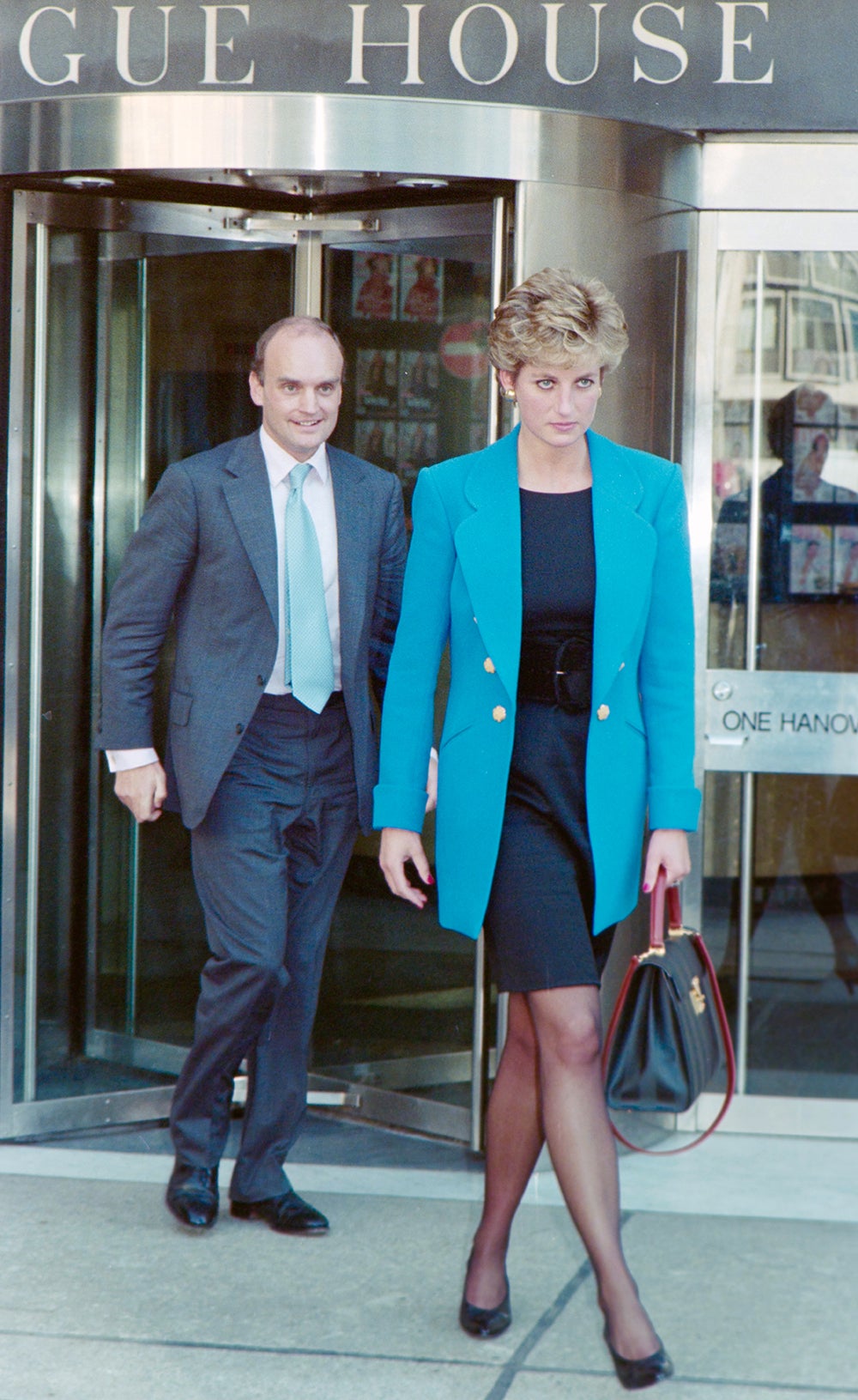 Sir Nicholas Coleridge and Princess Diana leave the Vogue House offices in 1994