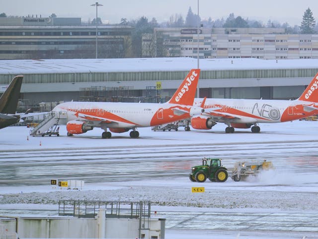 <p>A tractor clearing snow at Manchester Airport</p>