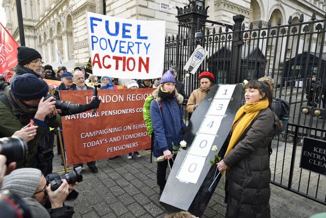 Protesters with a mock coffin as they campaign against people dying of cold and deliver a petition letter to 10 Downing Street (Beresford Hodge/PA)