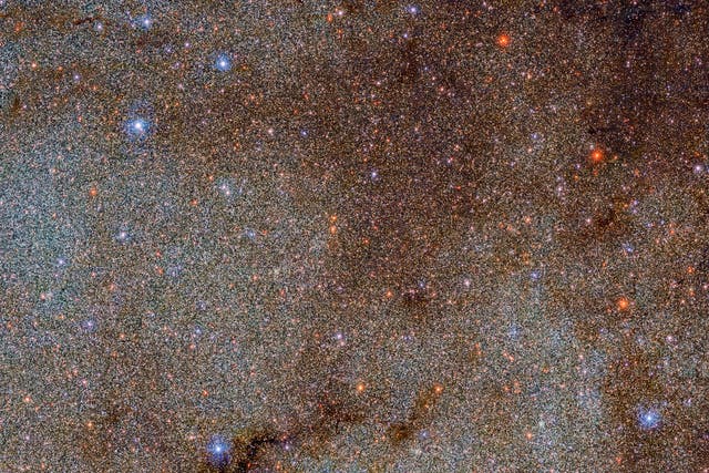 <p>This image, which is brimming with stars and dark dust clouds, is a small extract — a mere pinprick — of the full Dark Energy Camera Plane Survey (DECaPS2) of the Milky Way</p>