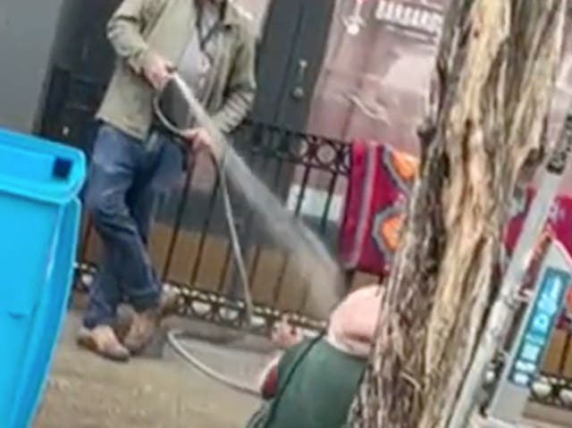 <p>San Francisco art gallery owner Collier Gwin sprays an unhoused woman with a hose outside his business</p>