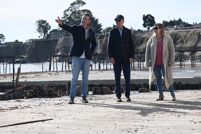 <p>President Joe Biden, California Governor Gavin Newsom, and a small business owner survey damage caused by recent heavy storms in Capitola, California</p>