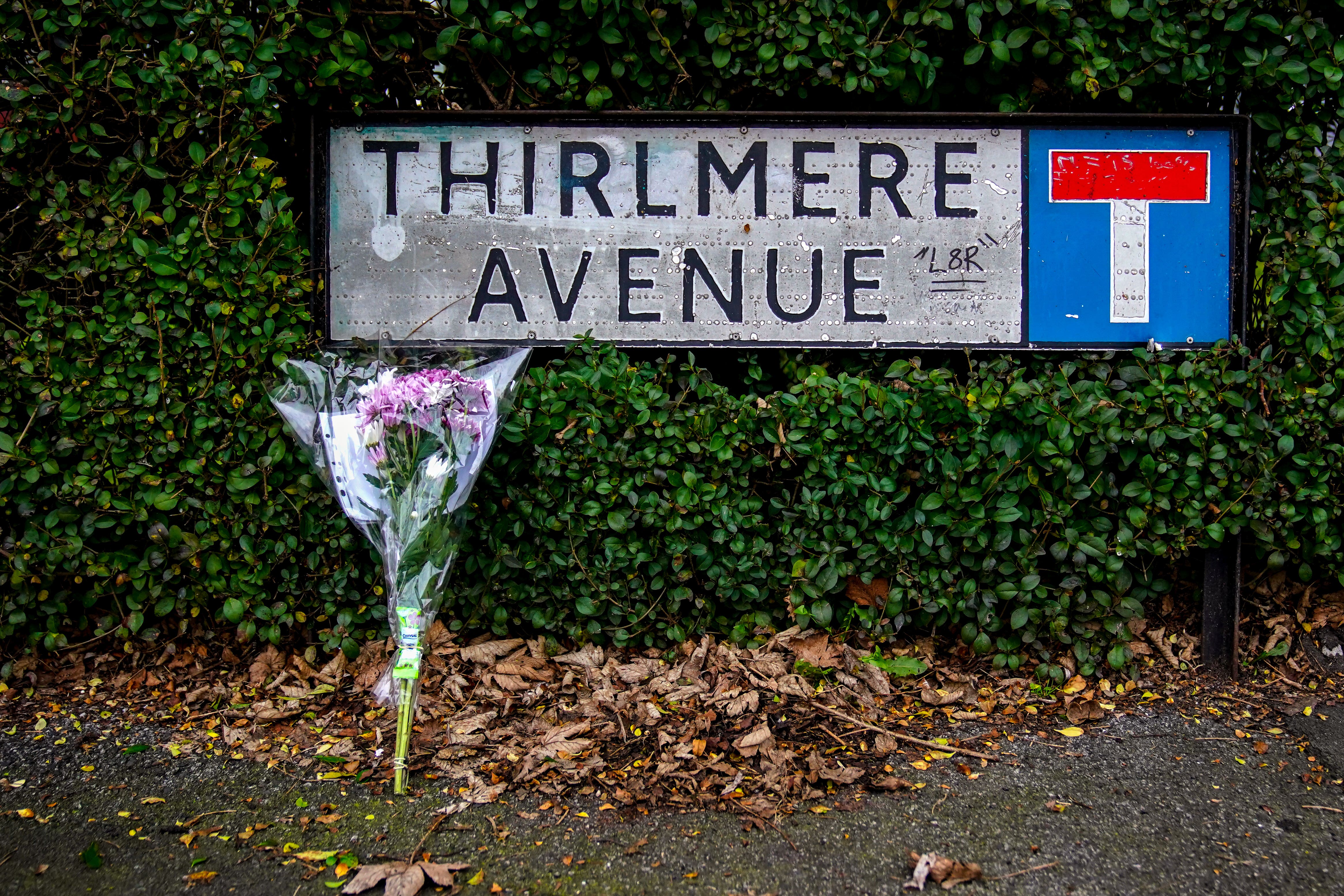 Flowers are left at the scene on Thirlmere Avenue in Stretford (PA)