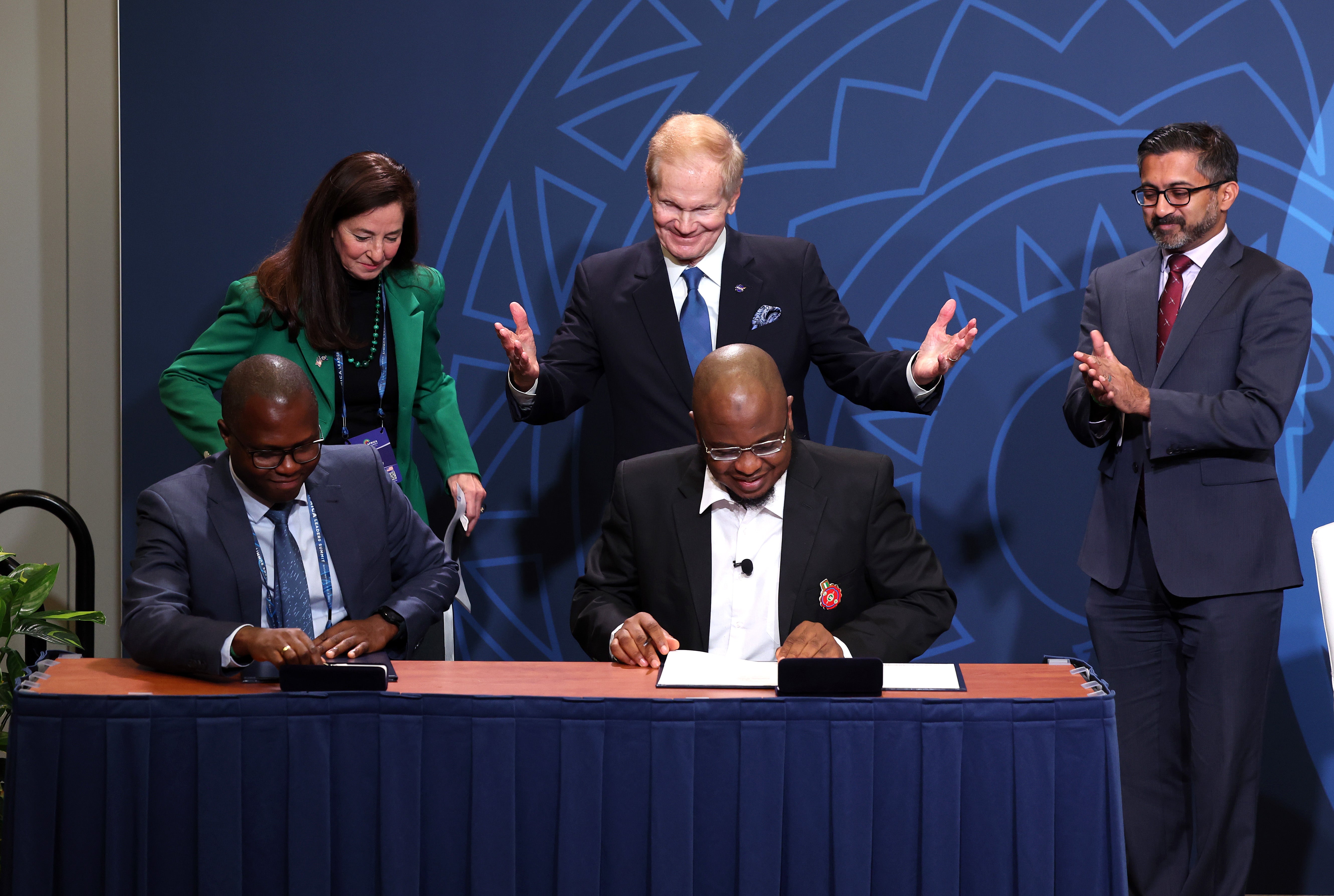 Nasa administrator Bill Nelson (centre) celebrates as Rwanda Space Agency director-general Colonel Francis Ngabo (left) and Nigerian minister of communications and digital economy Isa Ali Ibrahim (right) sign on to the Artemis Accords in December