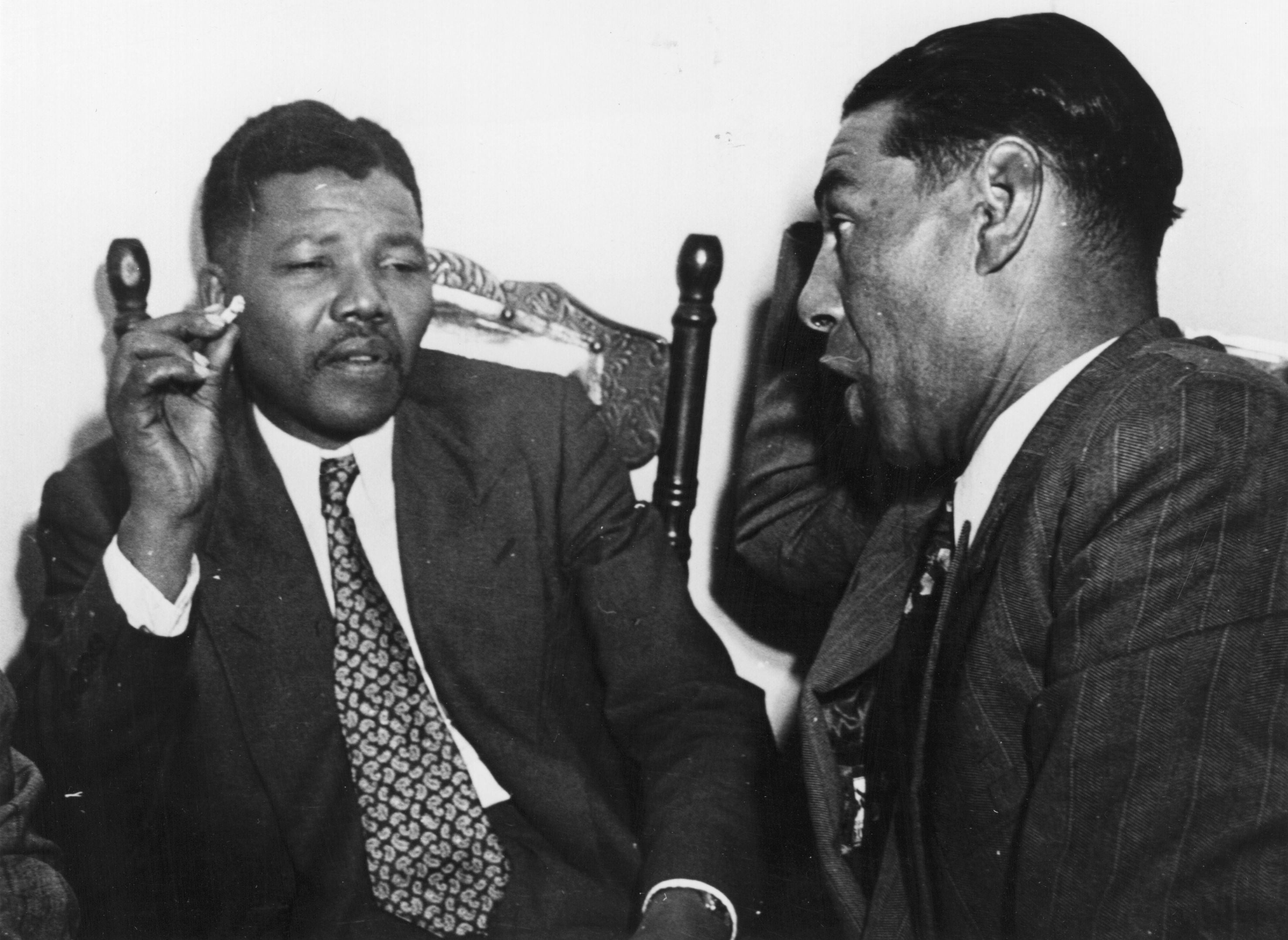 Mandela (left) speaks with a teacher in Cape Town, circa 1950