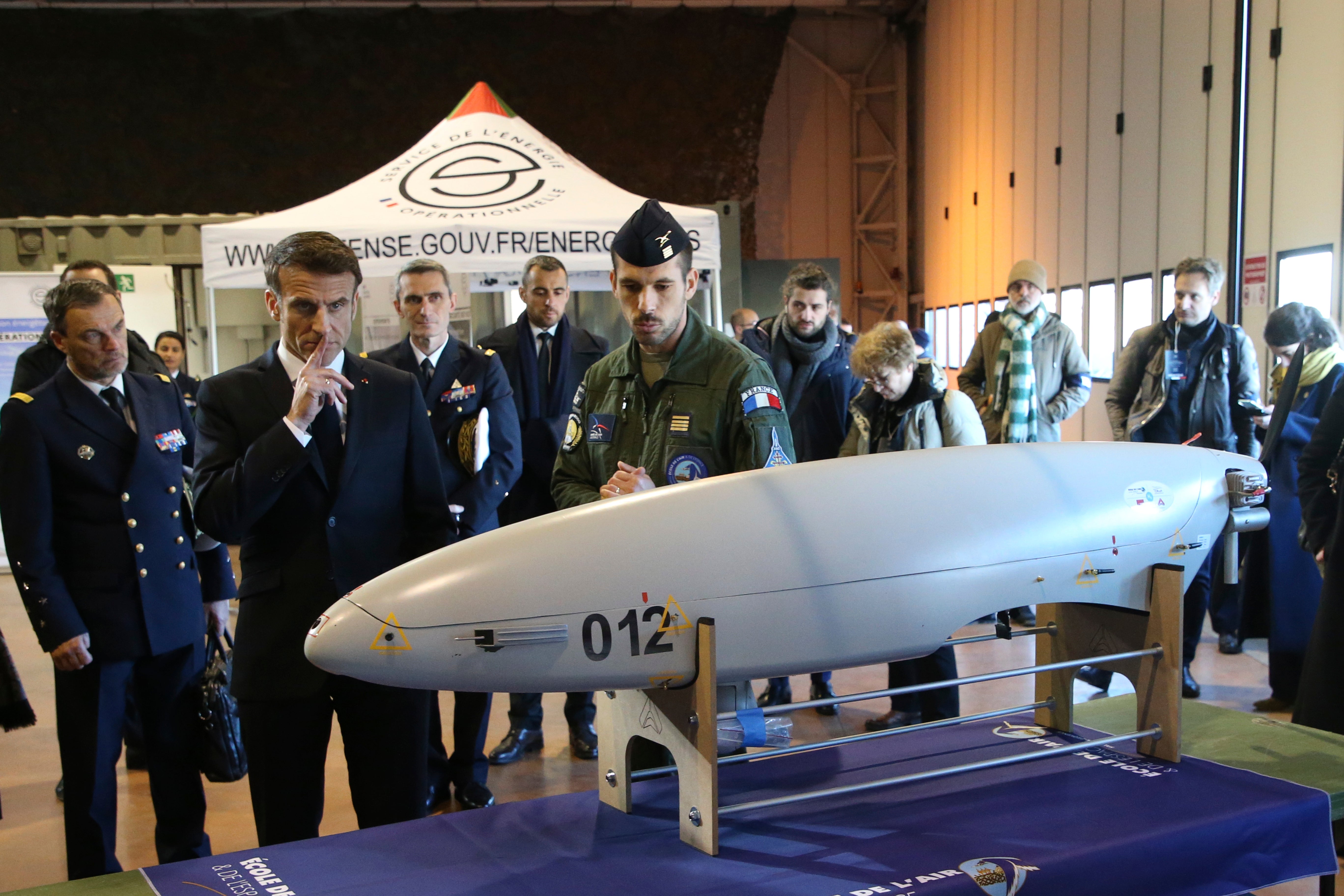 French President Emmanuel Macron views a military drone as he visits the Mont-de-Marsan air base