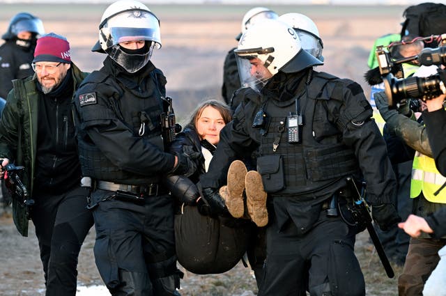 <p>Police officers carry Swedish climate activist Greta Thunberg away from the edge of the Garzweiler II opencast lignite mine during a protest action by climate activists after the clearance of Luetzerath, Germany</p>