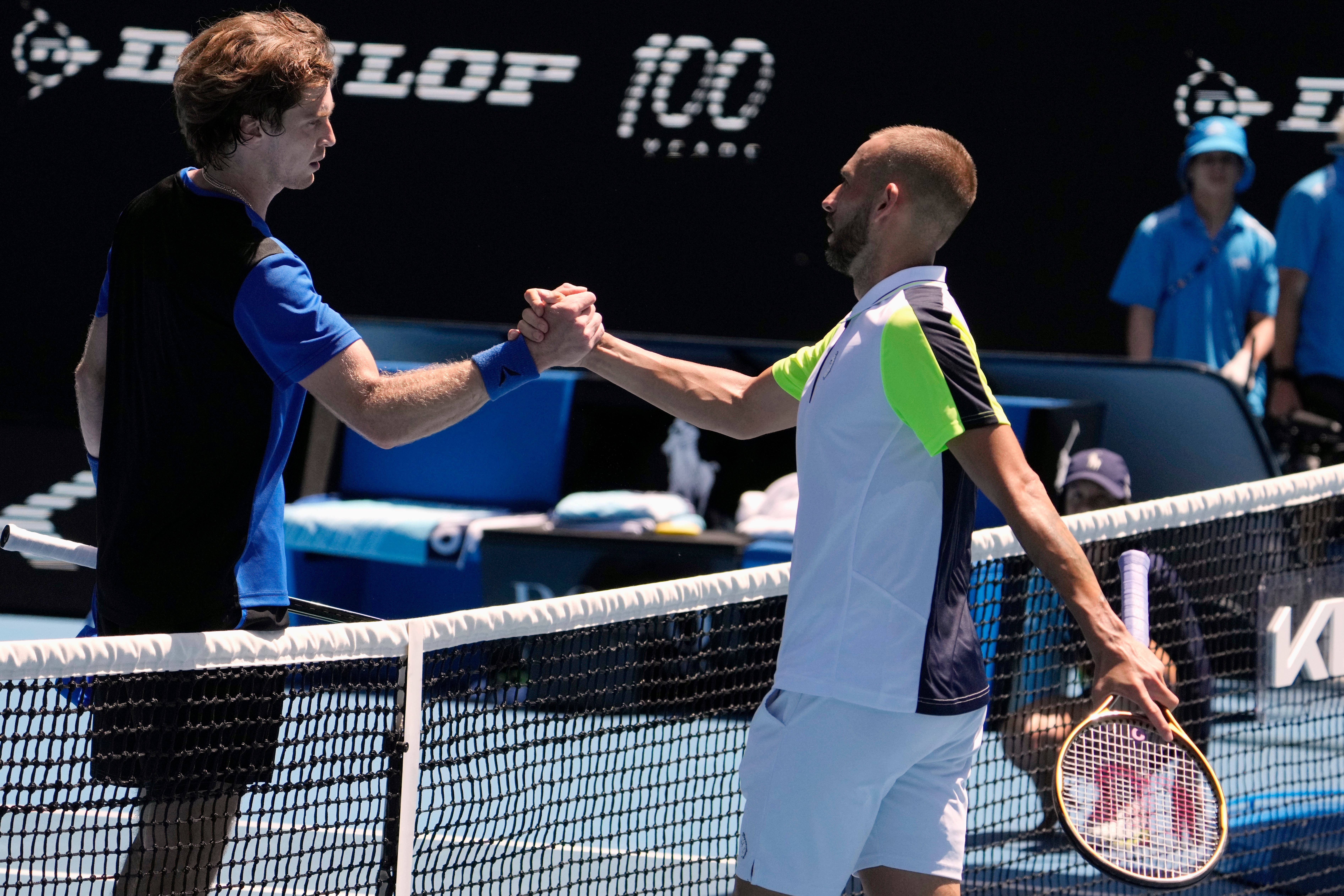 Dan Evans (right) congratulates Andrey Rublev (Ng Han Guan/AP)