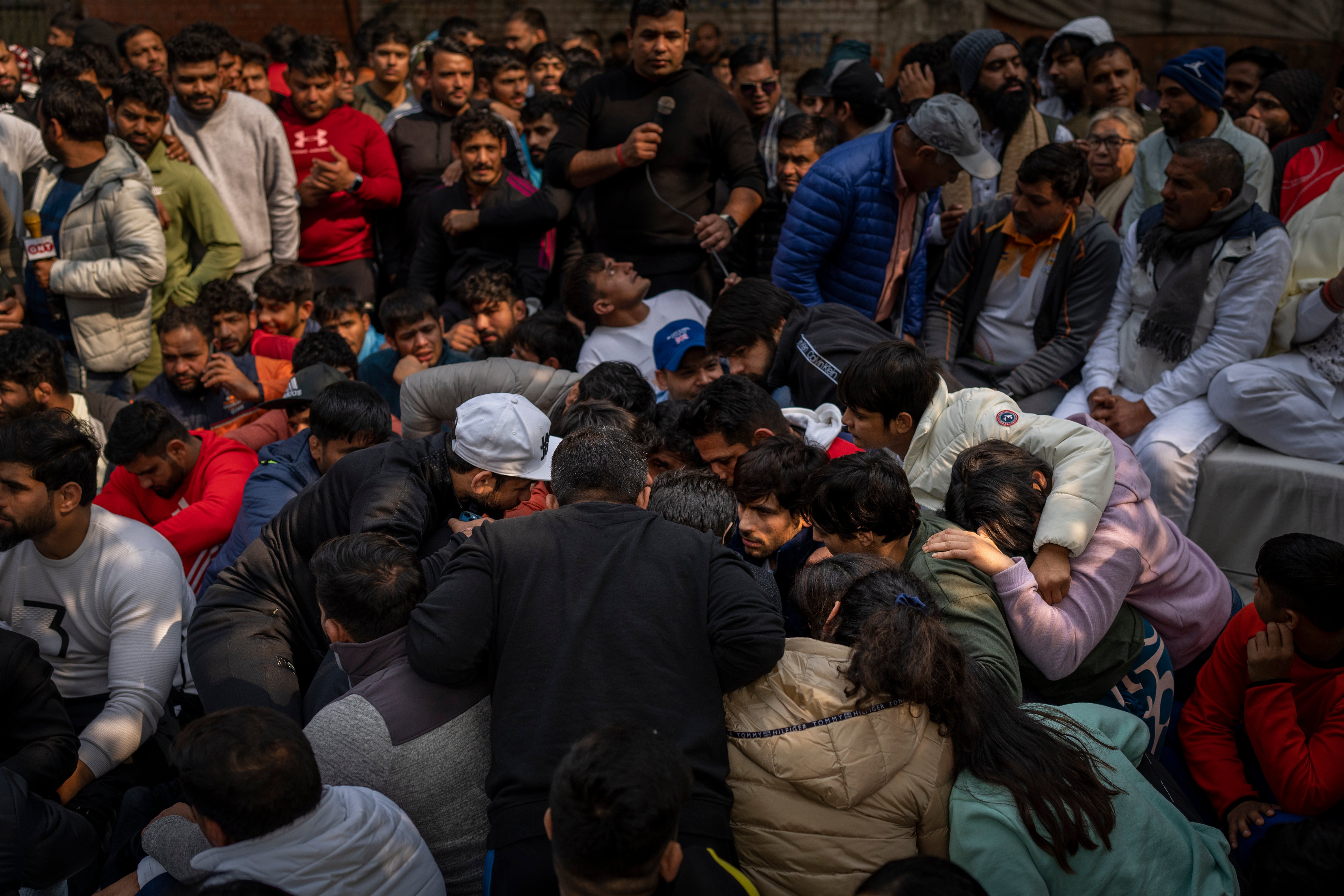 <p>Indian wrestlers huddle together as they deliberate during against Wrestling Federation of India President Brijbhushan Sharan Singh </p>