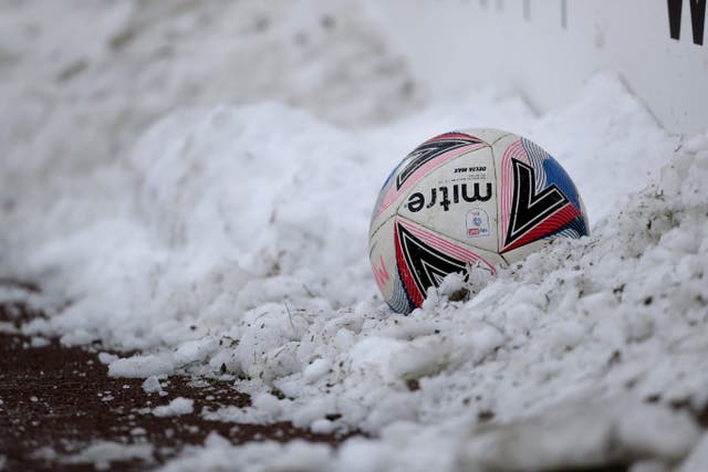 A view of a ball in the pitch side snow (Richard Sellers/PA)