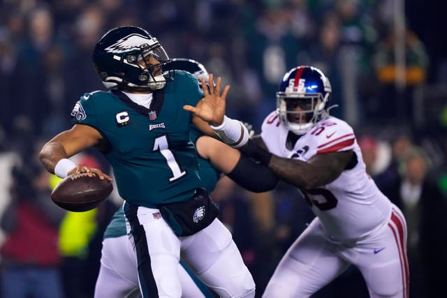Jalen Hurts, left, shook off his injury worries as he led the Philadelphia Eagles to the NFC Championship game with three touchdowns in a 38-7 humbling of the New York Giants (Matt Rourke/AP)