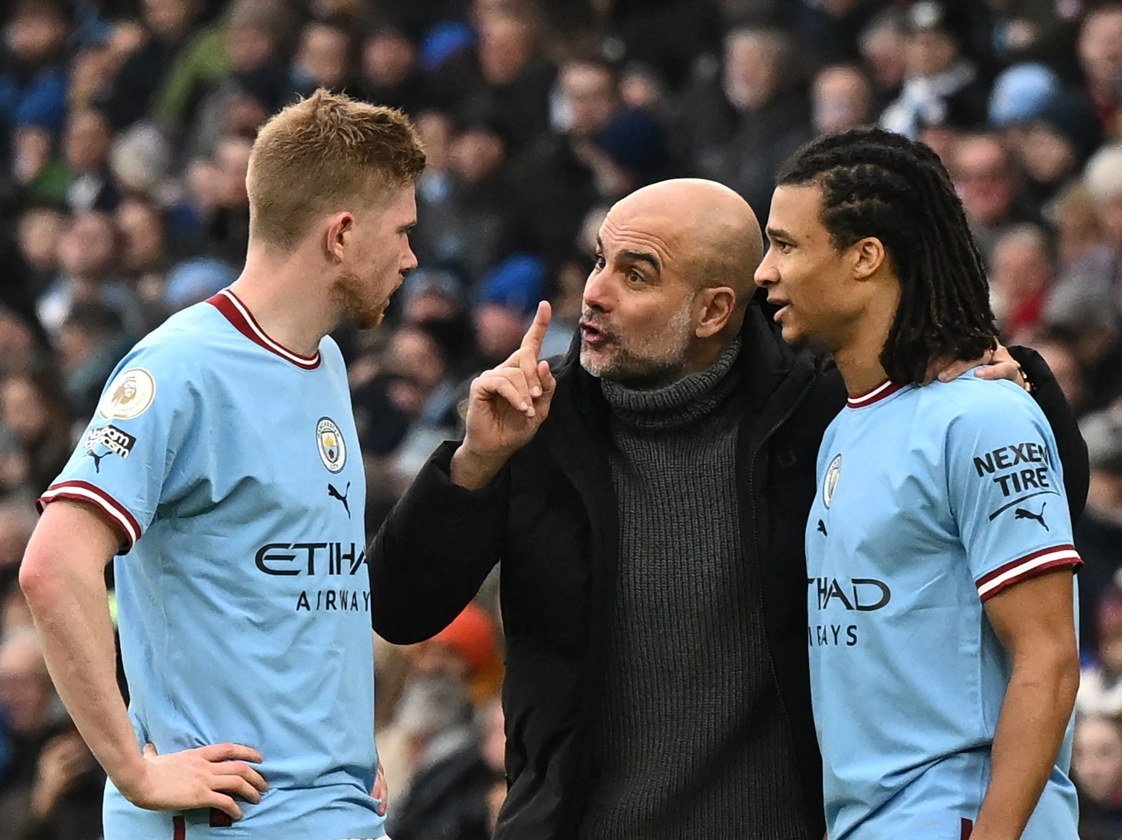 Pep Guardiola speaks with Kevin De Bruyne and Nathan Ake