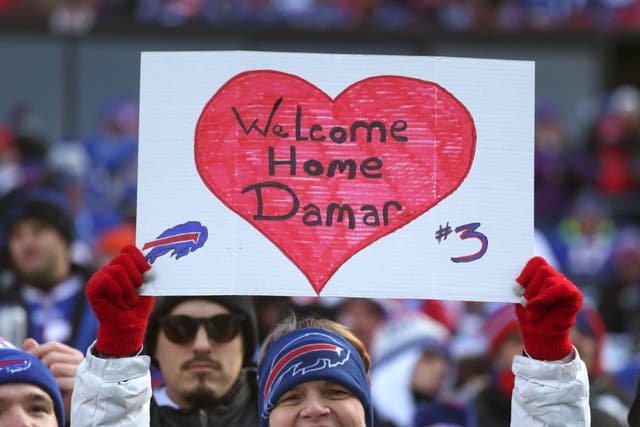 <p>A Buffalo Bills fan holds up a sign in support of Damar Hamlin</p>