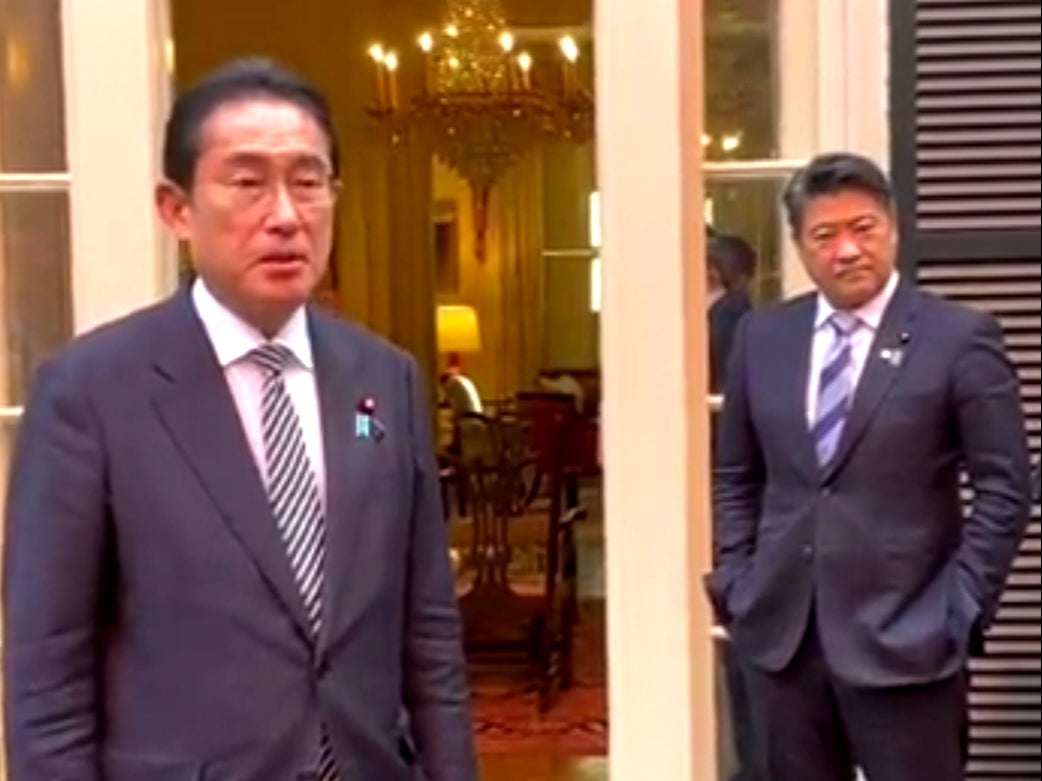 Fumio Kishida addresses reporters as aide Seiji Kihara looks on