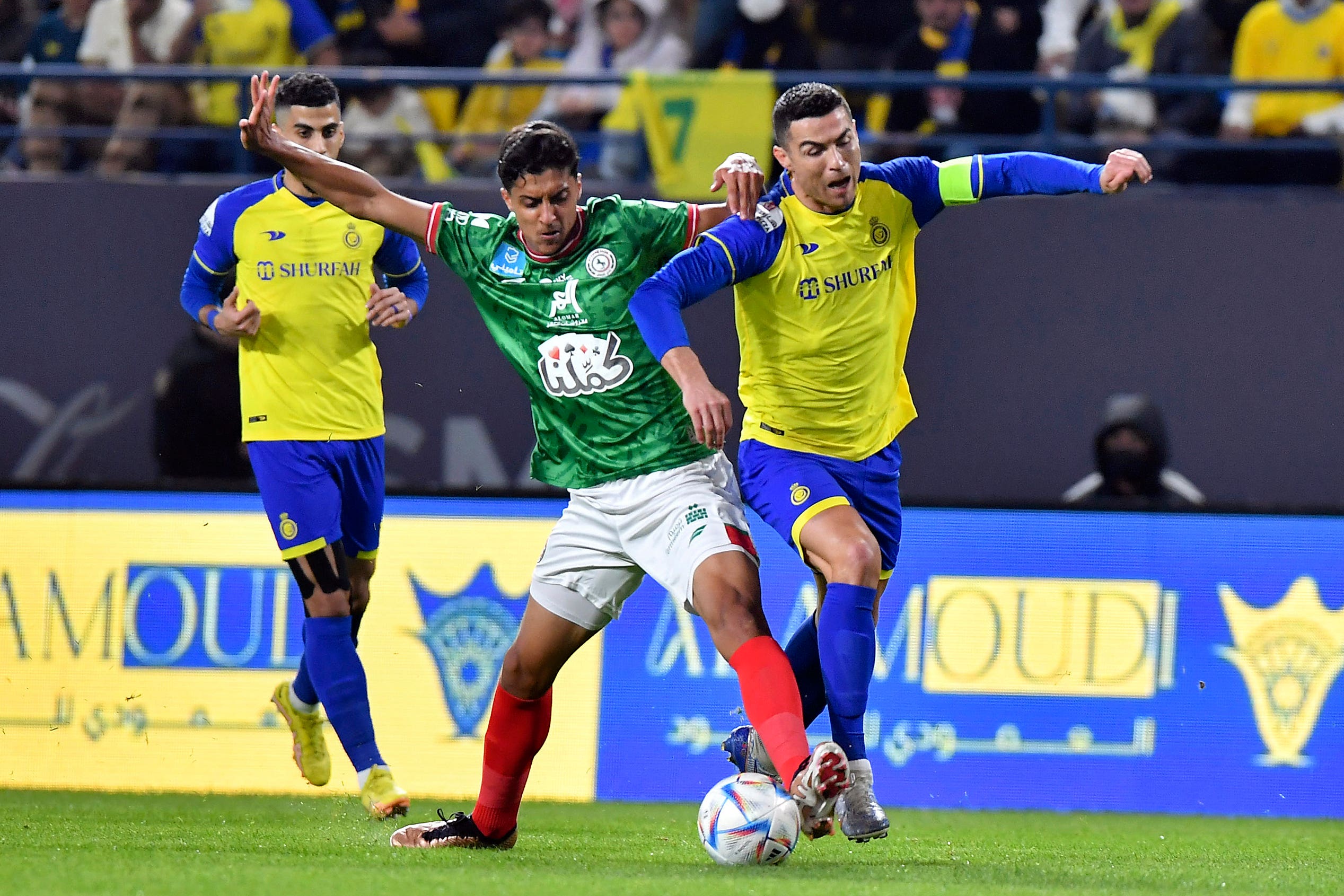 Al Nassr’s Cristiano Ronaldo, right, fights for the ball during the Saudi Pro League match between Al Ettifaq FC and Al Nassr FC at Mrsool Park Stadium, in Riyadh, Saudi Arabia, Sunday, Jan. 22, 2023. (AP Photo)