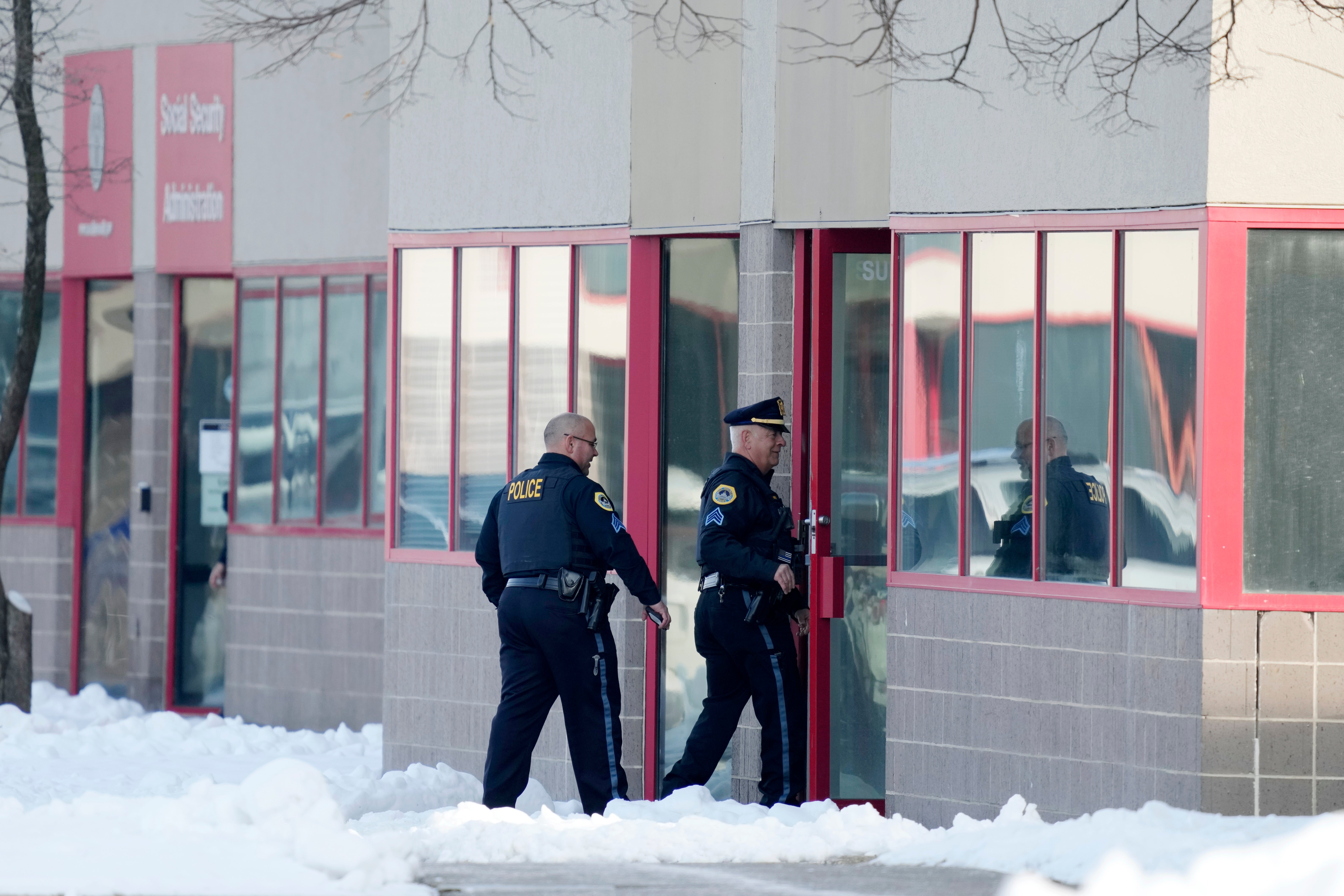 Police enter the Starts Right Here building in Des Moines, Iowa, where two students were killed and a teacher was injured in a shooting