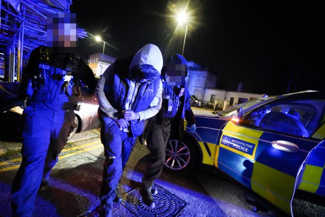 Officers from the Metropolitan Police arrest a suspect after a pursuit through Harlesden, north west London, as part of Operation Pandilla (Met Police/PA)