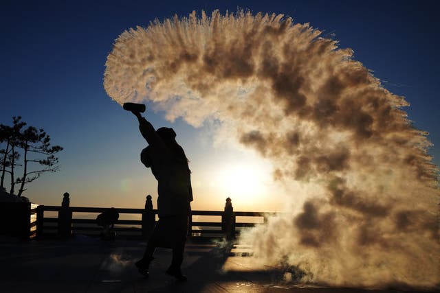 <p>A tourist pours water in the air in Heilongjiang Province, China,</p>