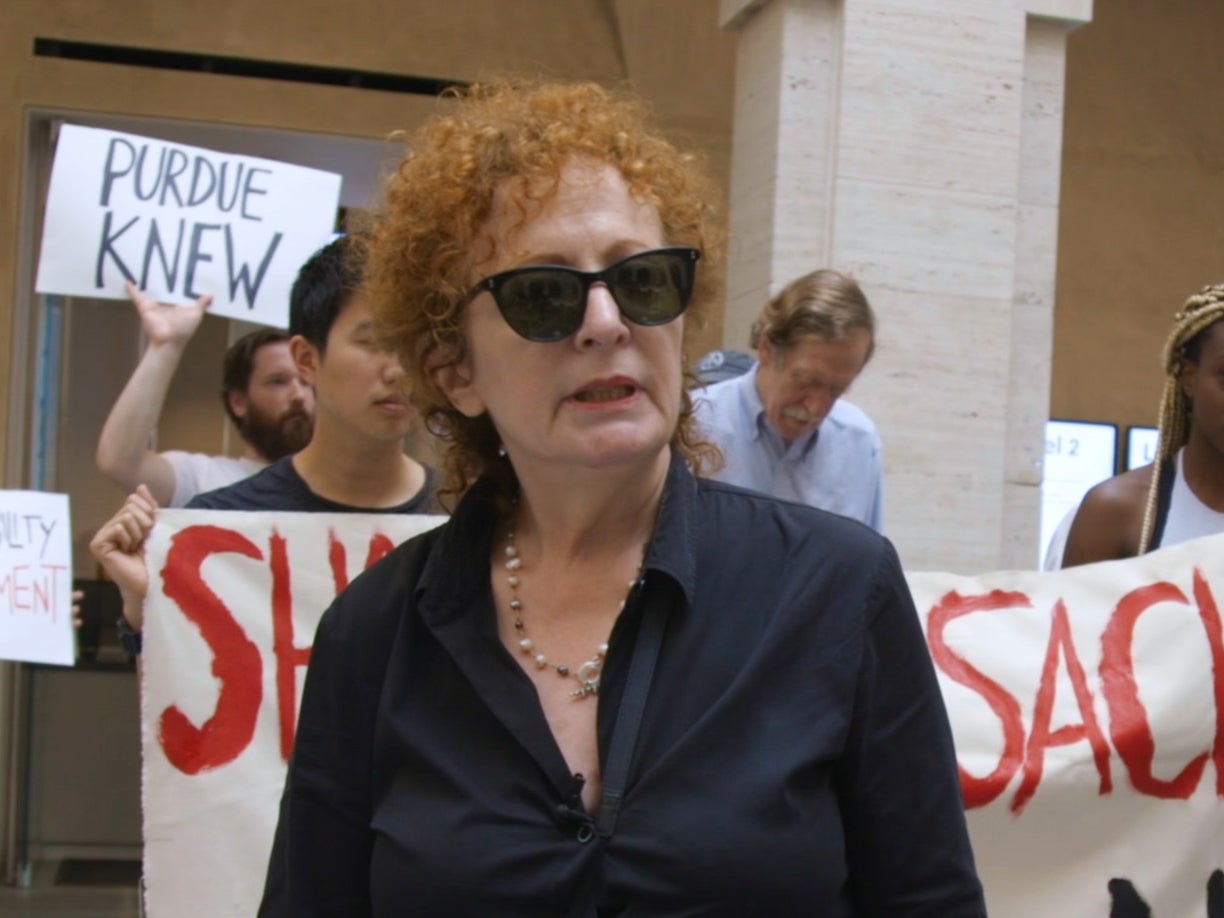 <p>Nan Goldin attending a protest against Purdue Pharma and the Sackler family, as seen in ‘All the Beauty and the Bloodshed’ </p>