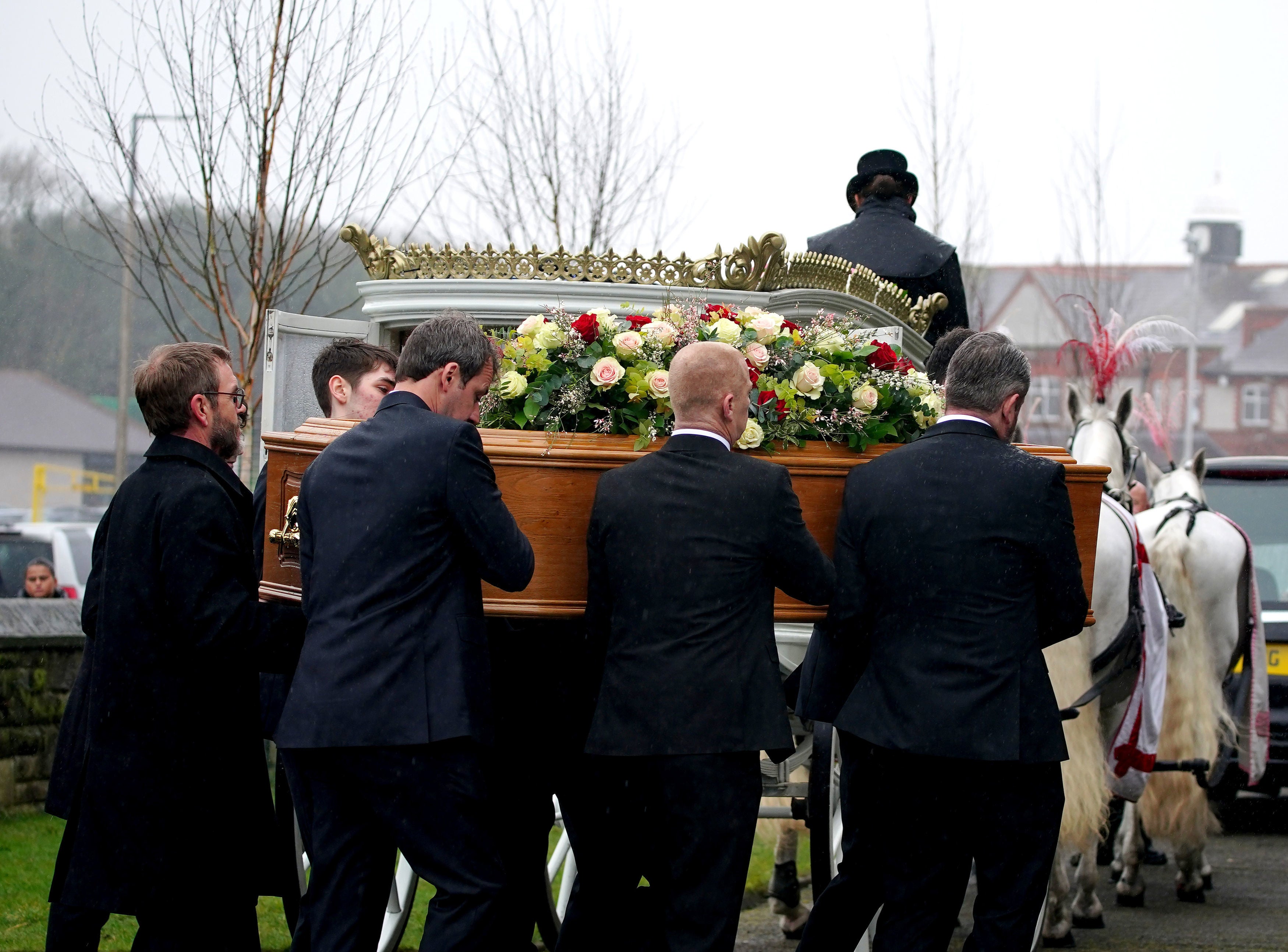 The bearer party carry Elle Edwards’ coffin into her funeral
