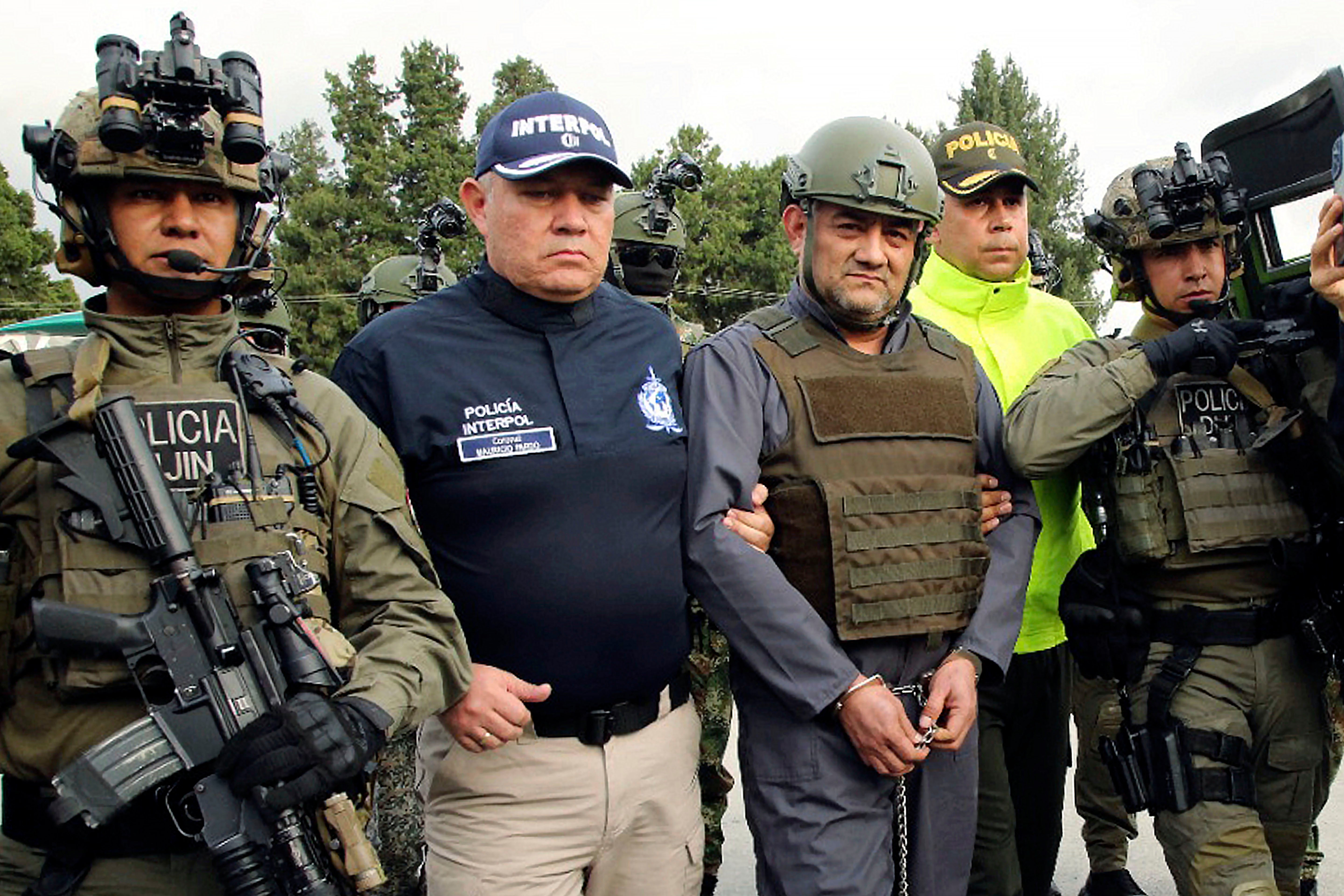 Police escort Dairo Antonio Usuga, known as Otoniel, at a military airport in Bogota, Colombia, in May 2022
