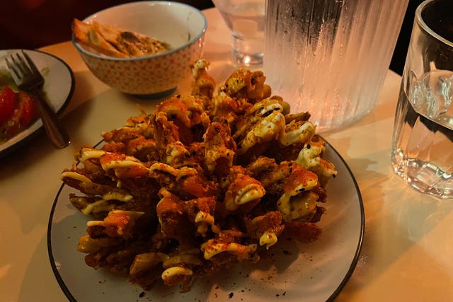 <p>Bloomin’ beautiful: The blooming onion with lashings of Kewpie mayo is something to behold </p>