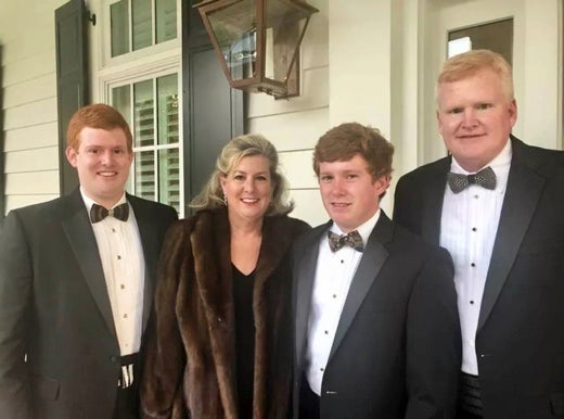 Alex Murdaugh is pictured with his son Buster, wife Maggie and son Paul