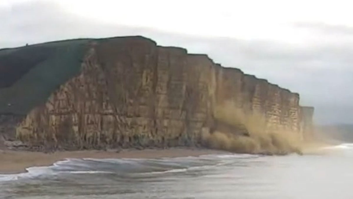 Watch moment massive chunk of West Bay cliff falls onto beach