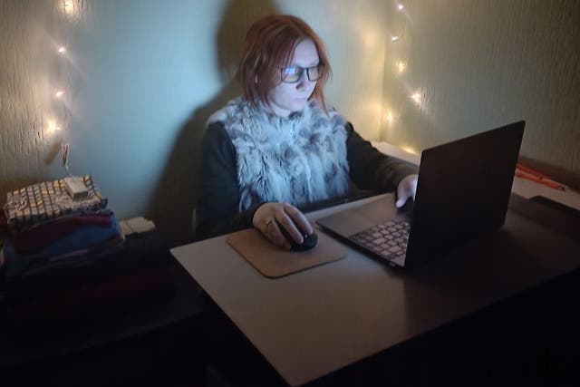 <p>Anastasia looks like any other web designer - but works under fairy lights in an improvised shelter</p>