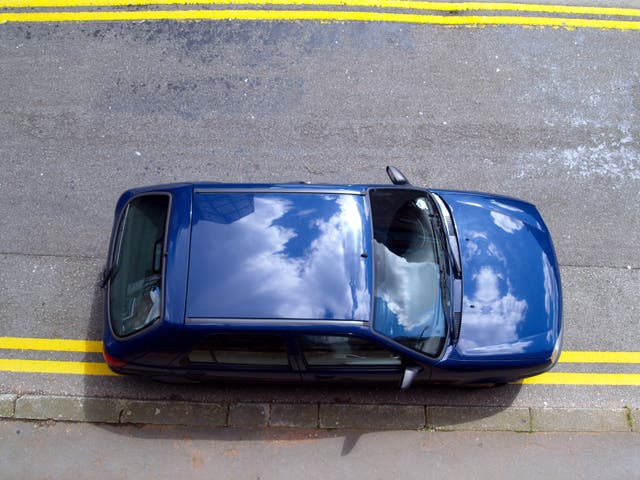 <p>A car illegally parked on double yellow lines</p>